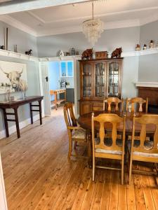 a dining room with a wooden table and chairs at Tily's Place in Parkes
