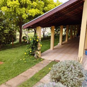 a pavilion in a park with trees and grass at Rancho Ca Fé - Casa Rural in Brazópolis