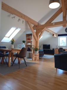 an open living room with a table and chairs at Ferienhaus am Bach im Bayerischen Wald in Achslach