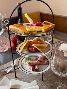a three tiered plate of food on a table at Gasthof Tenne - Ferie mit Härz in Lenk +20 photos
