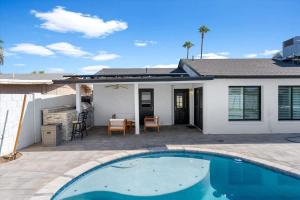 a house with a swimming pool in front of a house at Rock and Glam Paradise in Mesa