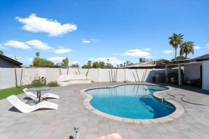 a backyard with a swimming pool and a patio at Rock and Glam Paradise in Mesa +30 photos