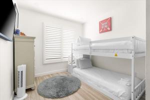 a bedroom with two bunk beds and a rug at Rock and Glam Paradise in Mesa