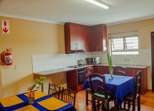 a kitchen with a table with a blue table cloth on it at Josef Self Catering in Swakopmund