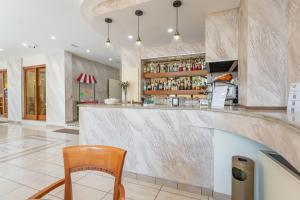 a bar with a wooden chair in a room at Hotel King in Rimini