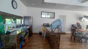 a room with a counter with a sink and a table at Casa Nueva en Condominio in Girardot