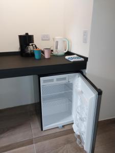a refrigerator with its door open on a counter at Dormi km3 in Comodoro Rivadavia