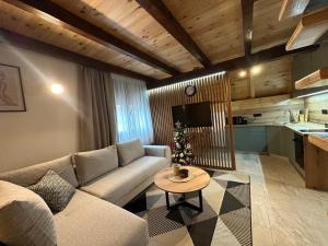 a living room with a couch and a table at Vila Ramonda in Žabljak
