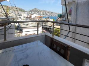 a balcony with a table and a view of a city at Pinkapartment Saranda in Sarandë