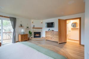 a bedroom with a bed and a fireplace at Tolovana 6 in Cannon Beach