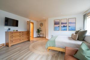 a bedroom with a large bed and a television at Tolovana 6 in Cannon Beach +52 photos