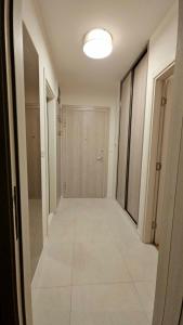 an empty hallway with a door and a tile floor at CL Home Lux in Podgorica