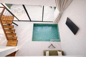 a room with a swimming pool in a house at Sumba Luxury Pool Cottages in Ko Phangan
