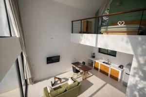 an open living room with a table and chairs at Sumba Luxury Pool Cottages in Ko Phangan