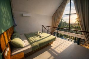 a bedroom with a bed and a balcony with a view at Sumba Luxury Pool Cottages in Ko Phangan +11 photos