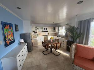 a kitchen with a table and a dining room at Bobby's Villa Beachfront, Paringao, La Union in Bauang