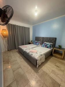 a bedroom with a bed and a lamp in it at Bobby's Villa Beachfront, Paringao, La Union in Bauang