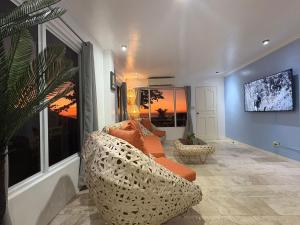 a living room with a couch and a large window at Bobby's Villa Beachfront, Paringao, La Union in Bauang