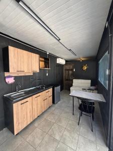 a kitchen with a sink and a table in it at Villa Sonia in Caldera