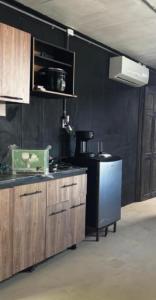 a kitchen with wooden cabinets and a black wall at Villa Sonia in Caldera