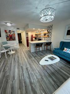 a living room with a blue couch and a table at Mid-Century Modern Beachfront in Flagler Beach +20 photos