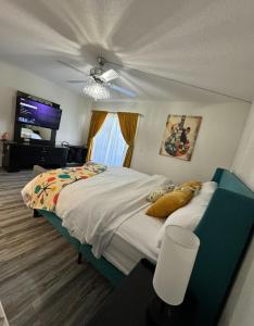 a bedroom with a bed and a flat screen tv at Mid-Century Modern Beachfront in Flagler Beach