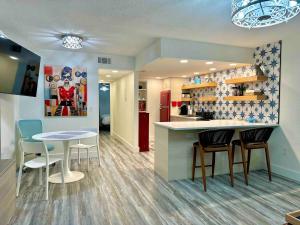 a kitchen and dining room with a table and chairs at Mid-Century Modern Beachfront in Flagler Beach