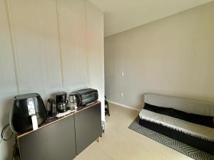 a small room with a bed in the corner at Apartamento Pousada Essence Navegantes Praia Gravata in Navegantes