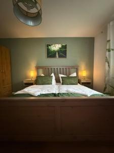 a bedroom with a large bed with two lamps on both sides at Mete Stays - Modern - Workspace - Cool location in Ingolstadt