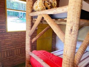 a wooden bunk bed with a red pillow in a room at Canto da Águia in Ouro Preto +9 photos