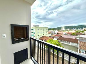 a balcony with a view of a city at Apartamento Pousada Essence Navegantes Praia Gravata in Navegantes