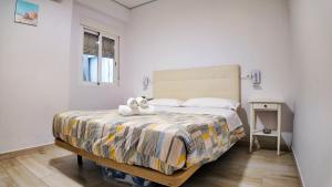a bedroom with a bed with a stuffed animal on it at Apartalux Benidorm's Port in Benidorm