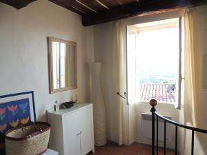 a living room with a window and a white cabinet at Ferienhaus in der Altstadt von Grimaud in Grimaud +20 photos