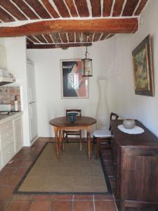 a kitchen with a table and a small table and chair at Ferienhaus in der Altstadt von Grimaud in Grimaud