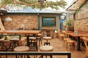 a bar with tables and stools in a restaurant at The Greenroof in Newcastle