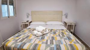 a bedroom with a bed with towels on it at Apartalux Benidorm's Port in Benidorm +42 photos