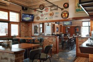a restaurant with tables and chairs and a bar at The Greenroof in Newcastle