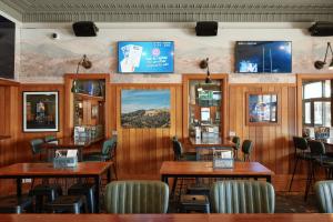 a restaurant with wooden walls and tables and chairs at The Greenroof in Newcastle