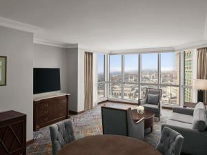 a living room with a view of a city at Swissotel Al Maqam Makkah in Mecca