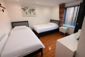 a room with two beds and a map on the wall at Tarleton house in Stoke on Trent