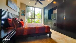 a bedroom with a bed and a large window at Citnos Luxury Accommodation in Telchac Puerto +80 photos