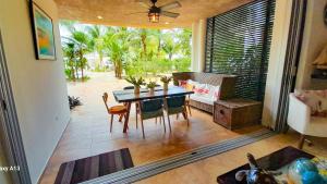 a dining room with a table and chairs and a window at Citnos Luxury Accommodation in Telchac Puerto