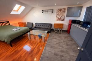 a living room with a bed and a kitchen at Tarleton house in Stoke on Trent