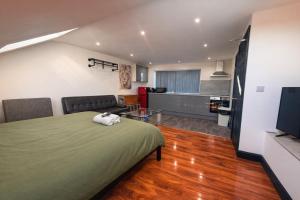 a bedroom with a bed and a living room at Tarleton house in Stoke on Trent
