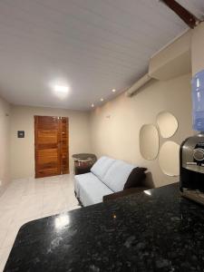 a living room with a bed and a couch at Kit net da flor in Fortim