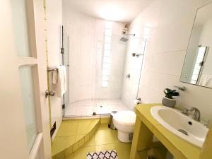 a bathroom with a toilet and a sink and a shower at Huacachina Boutique Hotel in Ica +61 photos