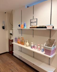 a shelf filled with lots of different colored bottles at hotel LUNA STELLA in Sendai
