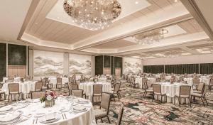 a banquet hall with white tables and chairs and a chandelier at Caesars Republic Lake Tahoe, A Caesars Destination in Stateline +75 photos