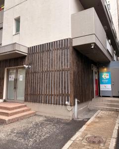 a building with a fence on the side of it at hotel LUNA STELLA in Sendai