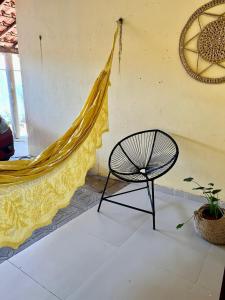 a hammock and a chair in a room at Casa Flor e Ser Rua Onezinda da Costa Barros ,80 in Parnaíba